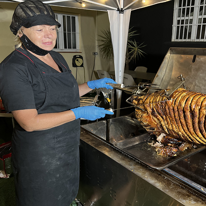 Julie is about to start serving the hog at an evening event